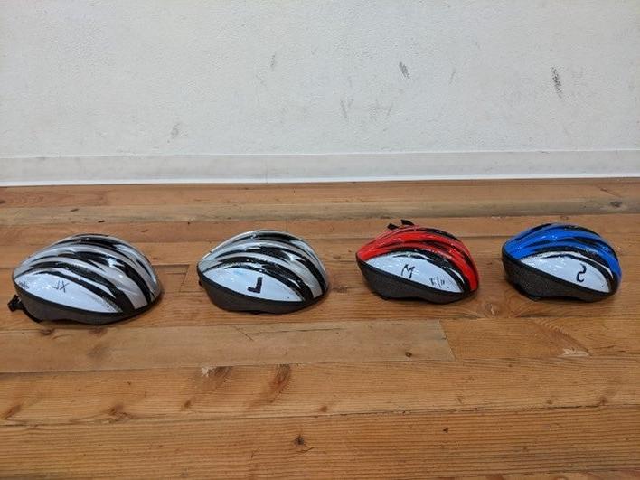 Helmets arranged by color and size.